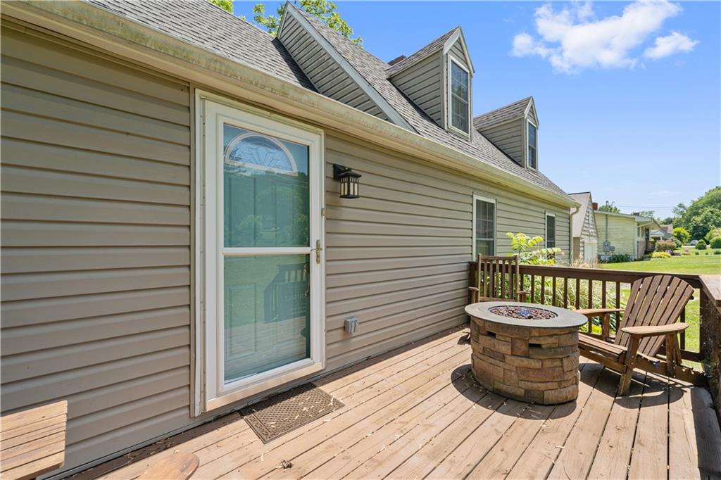 815 Arbor Ln Mount Mount Pleasant, PA 15666 - Photo 4 of 25 a view of a balcony with chair and wooden floor