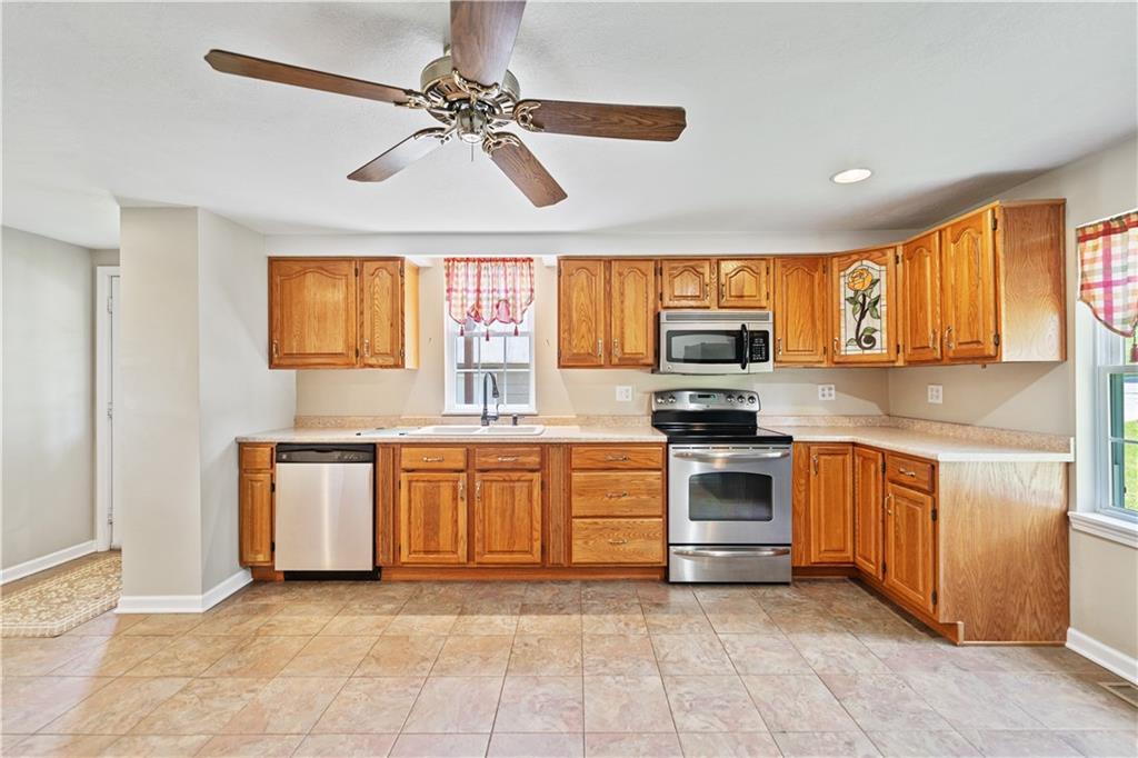 815 Arbor Ln Mount Mount Pleasant, PA 15666 - Photo 9 of 25 a kitchen with stainless steel appliances granite countertop a stove top oven a sink a window and stainless steel appliances