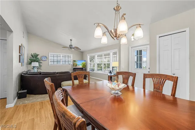 a view of a dining room with furniture a chandelier and wooden floor