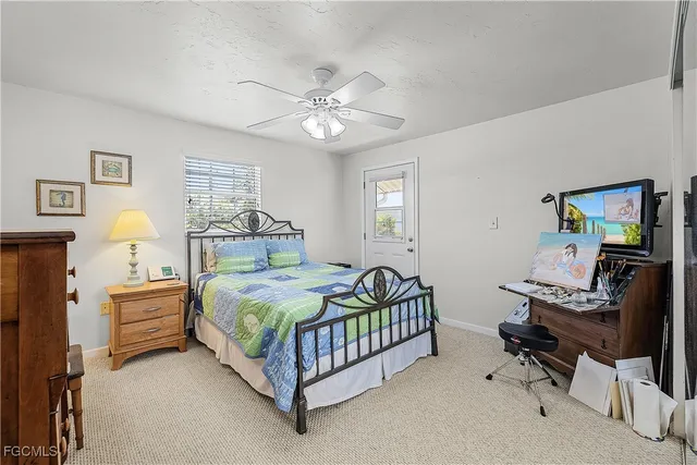 a bedroom with a bed window and a chandelier