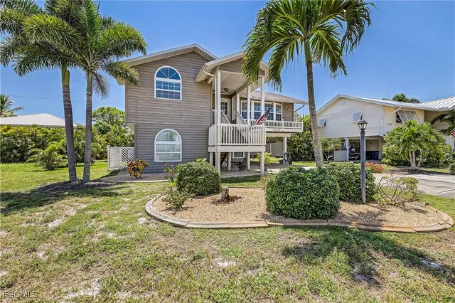 a front view of a house with yard and entryway