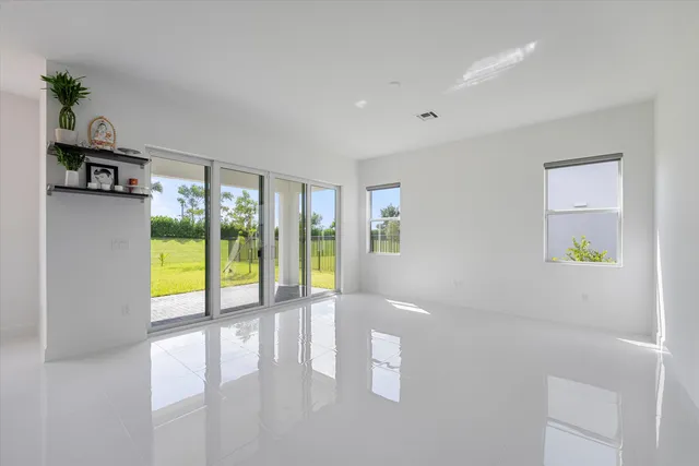a bathroom with a granite countertop sink a mirror and shower