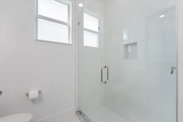an aerial view of a house with swimming pool and outdoor seating