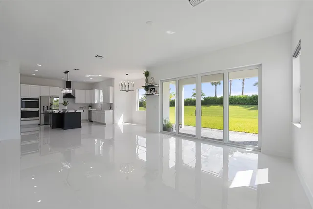 a large white kitchen with a large window