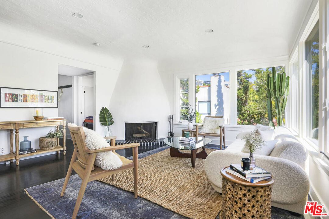 3003 Fall Avenue Los Angeles, CA 90026 - Photo 2 of 45 a living room with fireplace furniture and a large window