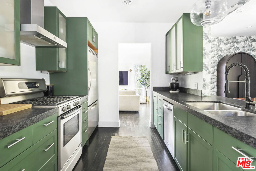 3003 Fall Avenue Los Angeles, CA 90026 - Photo 19 of 45 a kitchen with cabinets a sink and a stove