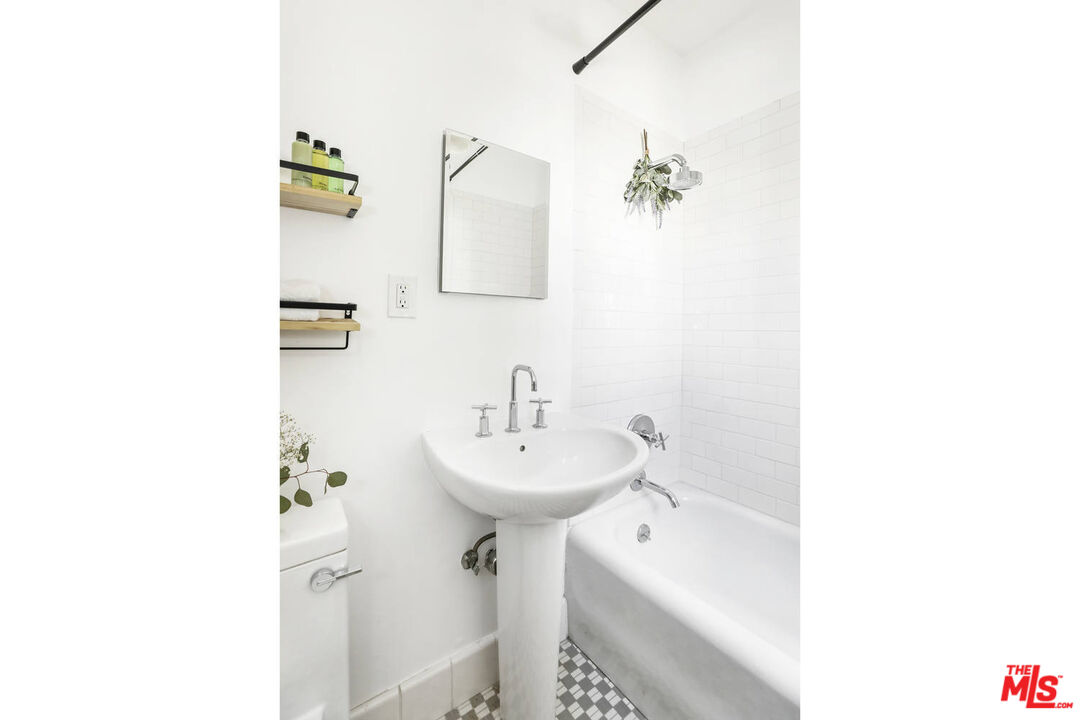 3003 Fall Avenue Los Angeles, CA 90026 - Photo 26 of 45 a bathroom with a sink a mirror and a shower