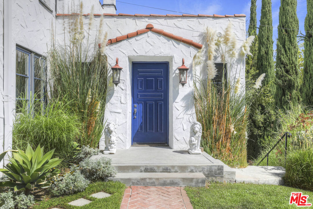 3003 Fall Avenue Los Angeles, CA 90026 - Photo 6 of 45 a front view of a house with a garden