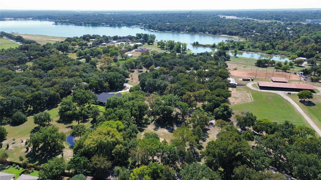 1325 Park Street Azle, TX 76020 - Photo 1 of 22 an aerial view of green landscape with trees houses and lake view