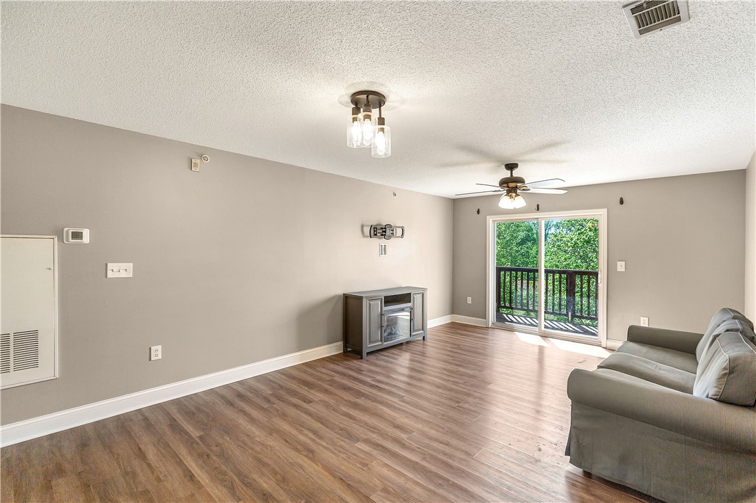 726 Lookover Drive Anderson, SC 29621 - Photo 13 of 32 This inviting living space features warm flooring, a balcony with views, and a comfortable atmosphere.