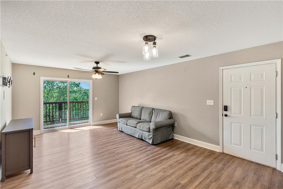 726 Lookover Drive Anderson, SC 29621 - Photo 14 of 32 This bright living space features wood flooring, a ceiling fan, and access to a private balcony.
