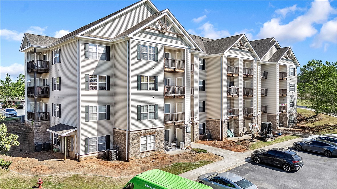 726 Lookover Drive Anderson, SC 29621 - Photo 2 of 32 This modern multi-story residential building features balconies and classic shutters, blending comfort with architectural appeal.