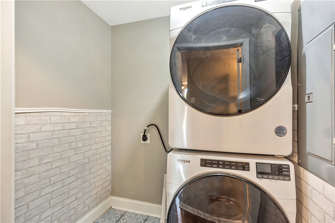 726 Lookover Drive Anderson, SC 29621 - Photo 23 of 32 This dedicated space offers convenient laundry solutions with modern, stacked appliances and durable flooring.