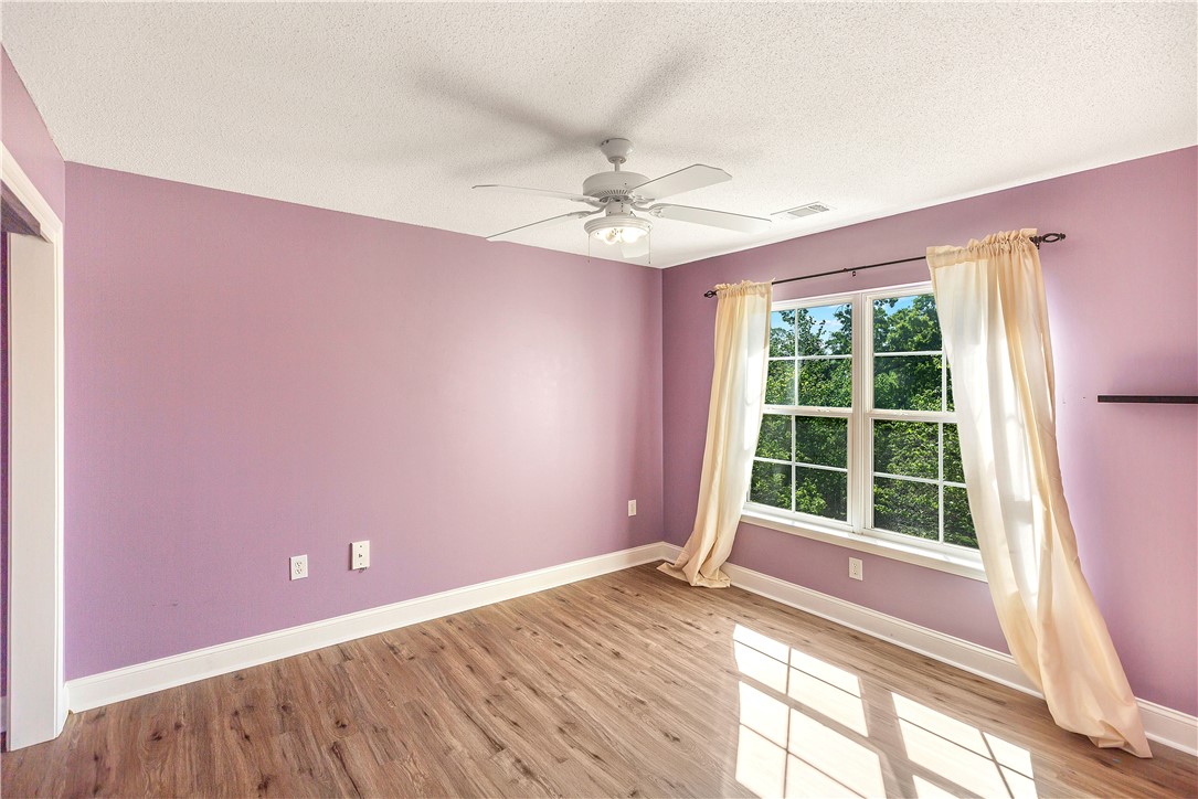 726 Lookover Drive Anderson, SC 29621 - Photo 26 of 32 This airy bedroom features abundant natural light and wood flooring, creating a serene and inviting atmosphere.