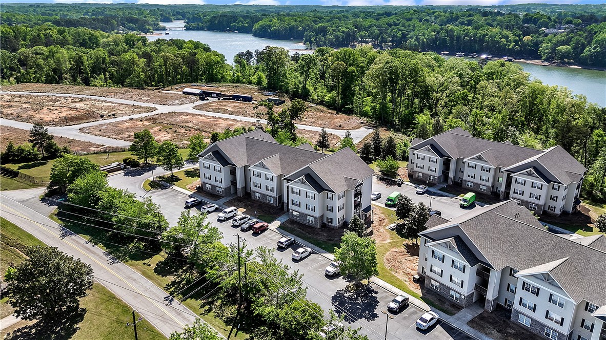 726 Lookover Drive Anderson, SC 29621 - Photo 4 of 32 These modern apartment buildings offer a serene lakeside community living experience.