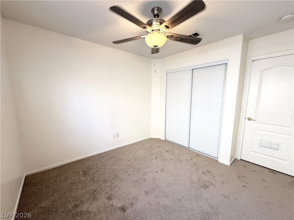 8870 Haviland Road Las Vegas, NV 89123 - Photo 12 of 22 A well-proportioned bedroom offers comfort with plush carpeting and a modern ceiling fan.