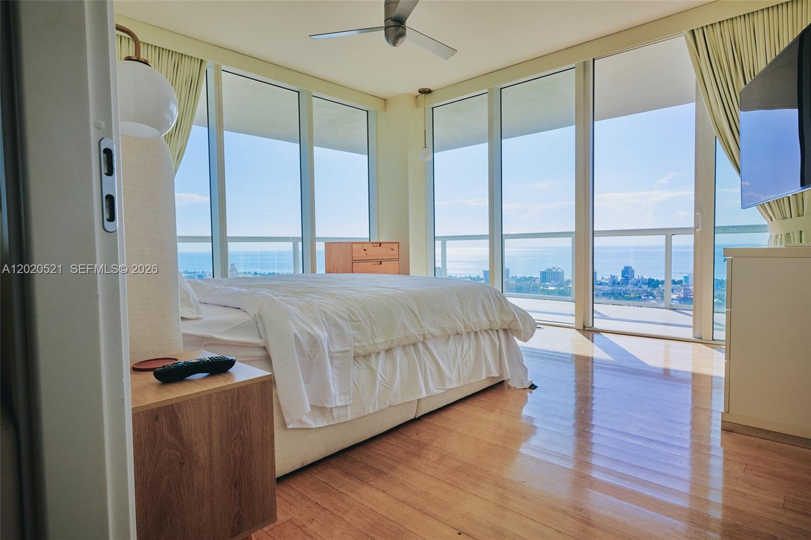 450 Alton Road, Unit 2810 Miami Beach, FL 33139 - Photo 9 of 29 a bedroom with a large bed and a large window