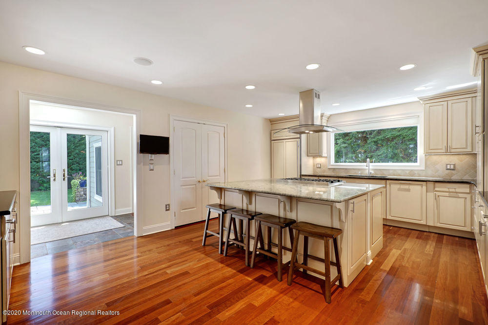 27 Southern Way Princeton, NJ 08540 - Photo 7 of 63 a kitchen with stainless steel appliances granite countertop a stove top oven a sink dishwasher and a dining table with wooden floor