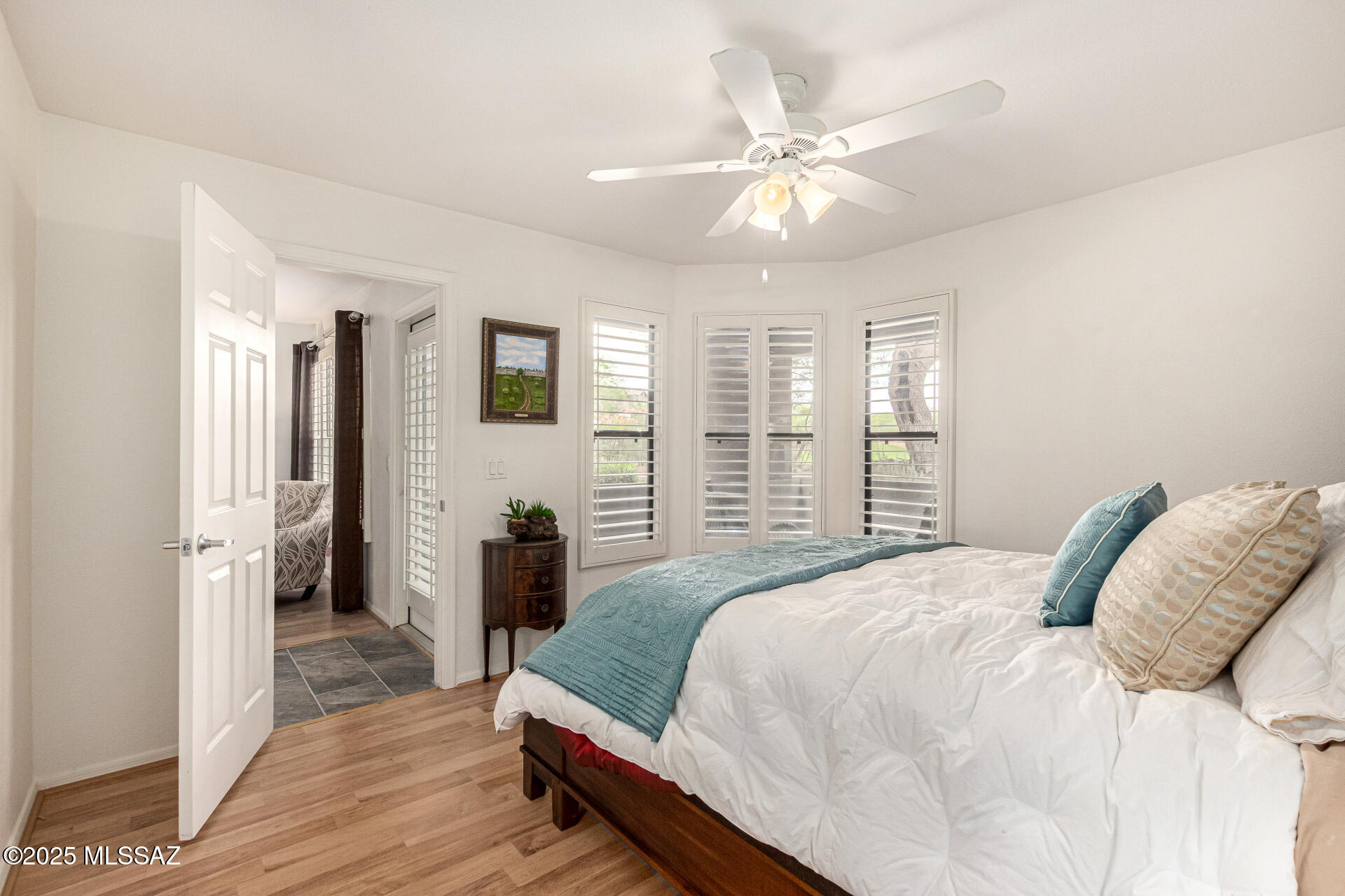 5855 North Kolb Road, Unit 8102 Tucson, AZ 85750 - Photo 5 of 28 a bedroom with a large bed and a chandelier