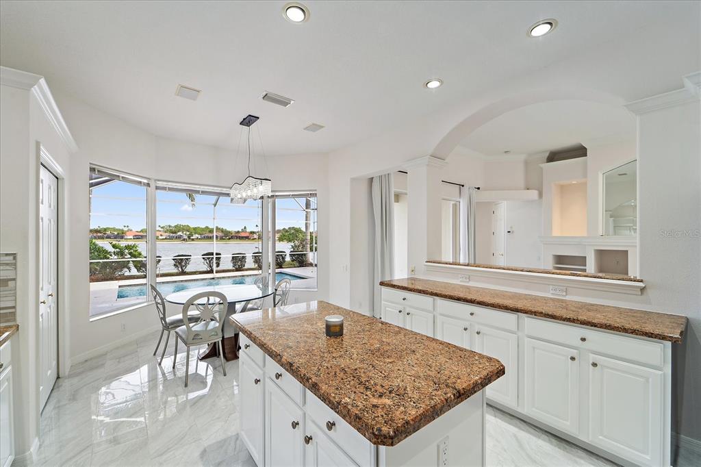 6585 Waters Edge Way Lakewood Ranch, FL 34202 - Photo 13 of 59 a kitchen with a table and chairs in it