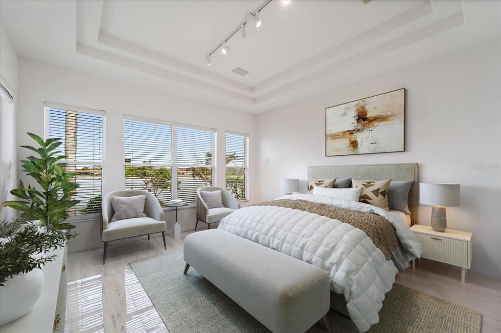 6585 Waters Edge Way Lakewood Ranch, FL 34202 - Photo 16 of 59 a bedroom with a large bed and a couch