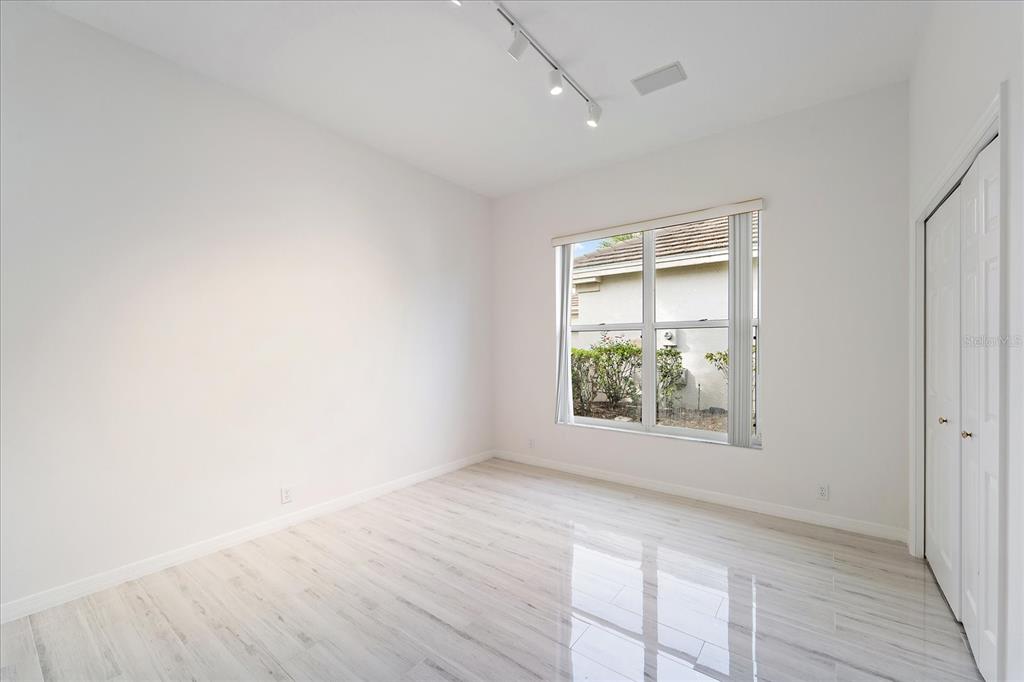 6585 Waters Edge Way Lakewood Ranch, FL 34202 - Photo 23 of 59 an empty room with wooden floor and windows