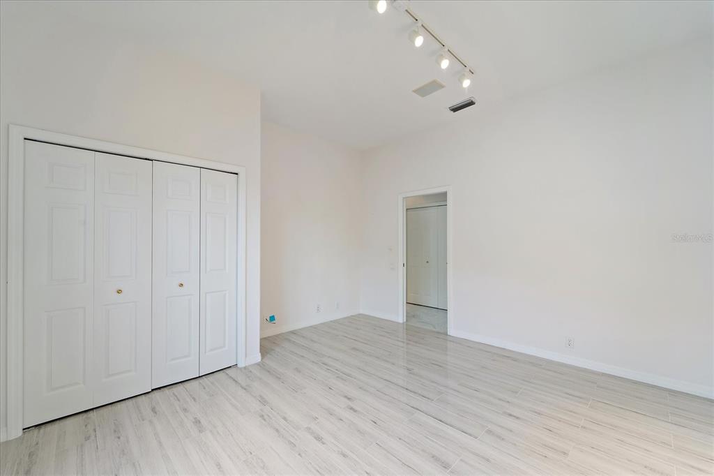 6585 Waters Edge Way Lakewood Ranch, FL 34202 - Photo 25 of 59 a view of an empty room with wooden floor