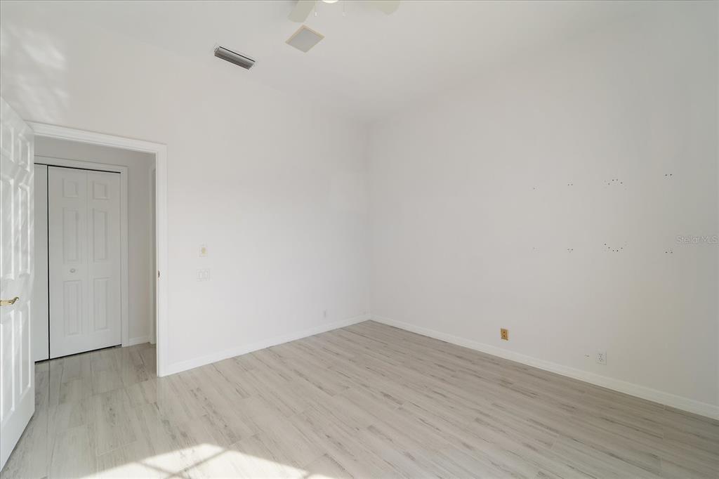 6585 Waters Edge Way Lakewood Ranch, FL 34202 - Photo 30 of 59 a view of a room with wooden floor and white walls