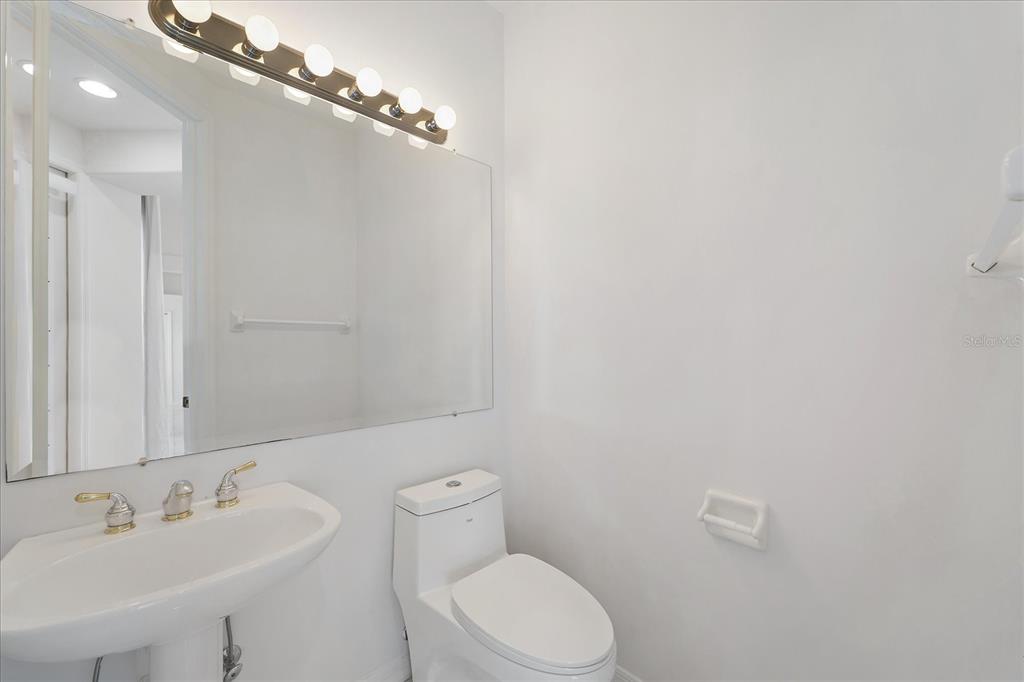 6585 Waters Edge Way Lakewood Ranch, FL 34202 - Photo 31 of 59 a bathroom with a toilet a sink and mirror