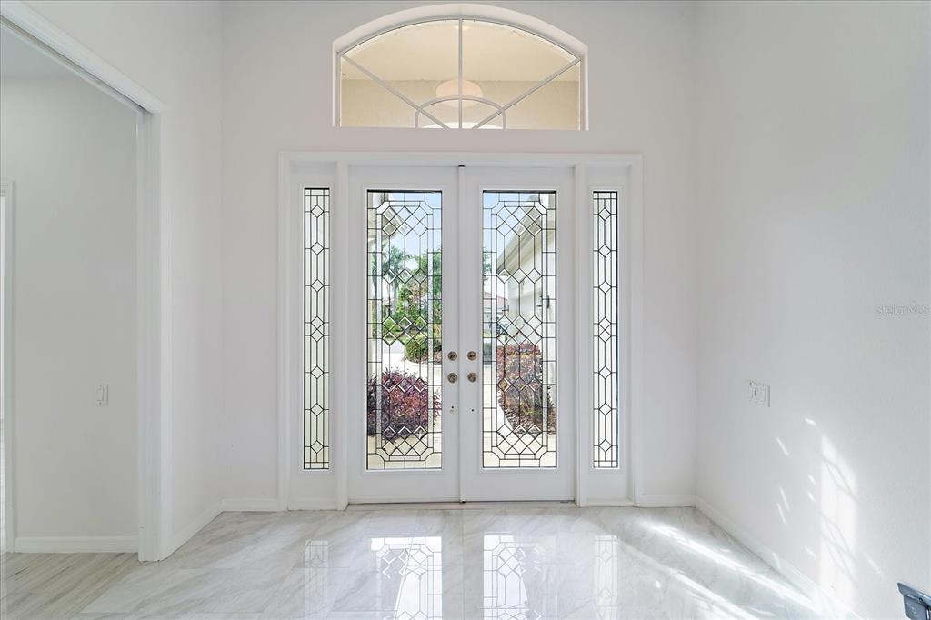 6585 Waters Edge Way Lakewood Ranch, FL 34202 - Photo 4 of 59 an empty room with wooden floor and windows