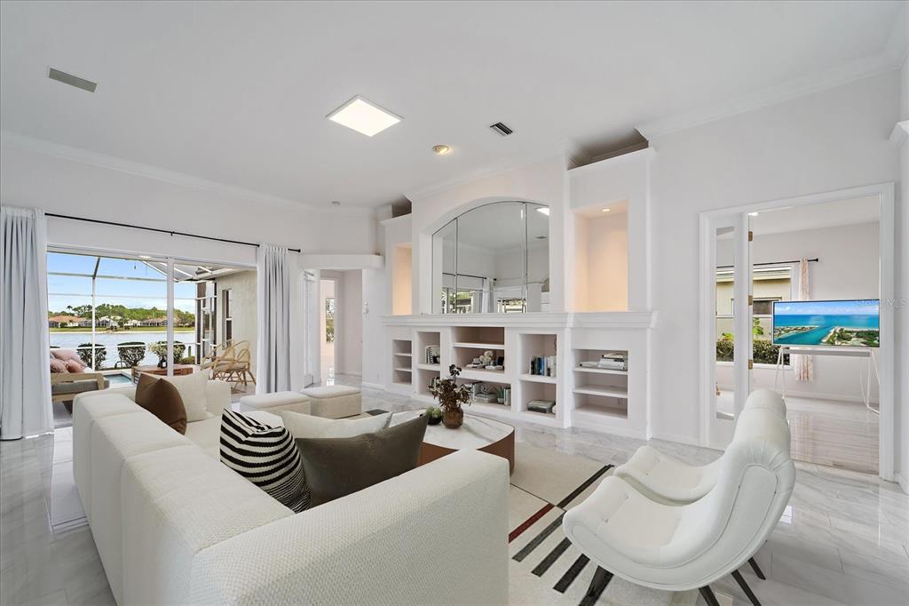 6585 Waters Edge Way Lakewood Ranch, FL 34202 - Photo 5 of 59 a living room with furniture kitchen view and a large window