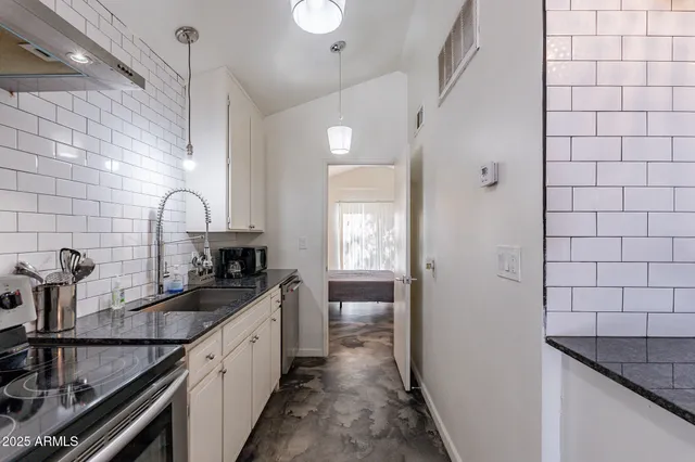 a kitchen with a sink and cabinets