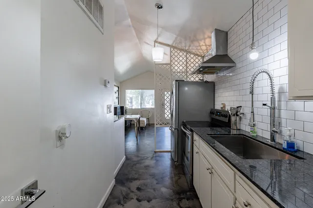 a kitchen with sink cabinets and appliances