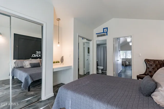 a bedroom with a bed and a mirror