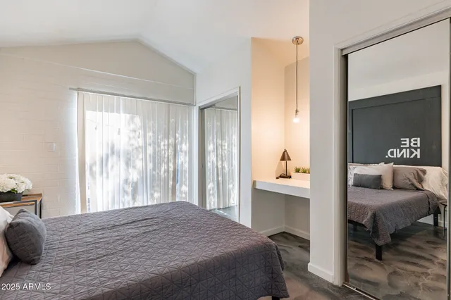 a bedroom with a bed and a window