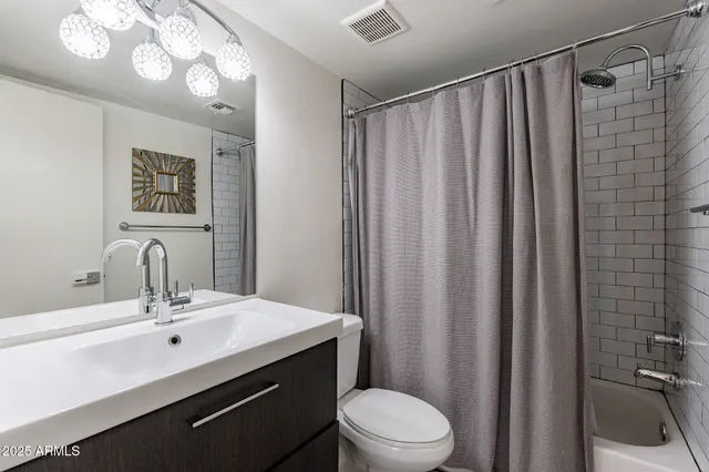 a bathroom with a sink vanity mirror and toilet