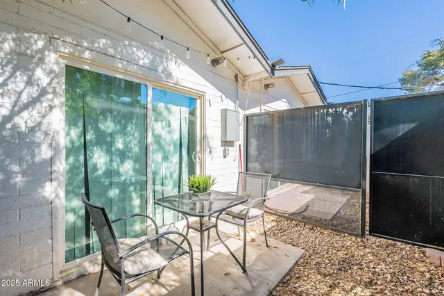 a view of a patio with table and chairs and potted plants