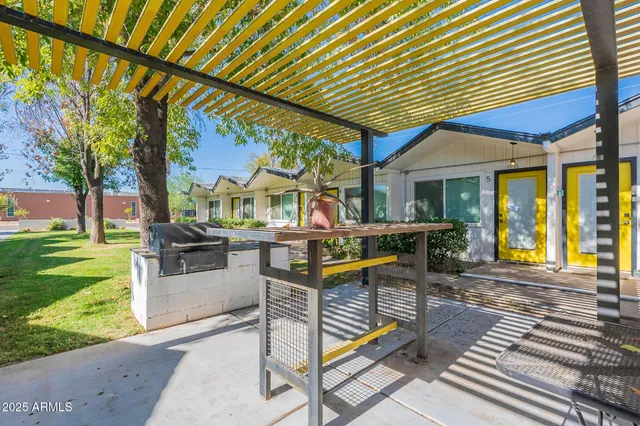 a view of a patio with table and chairs with wooden floor and fence