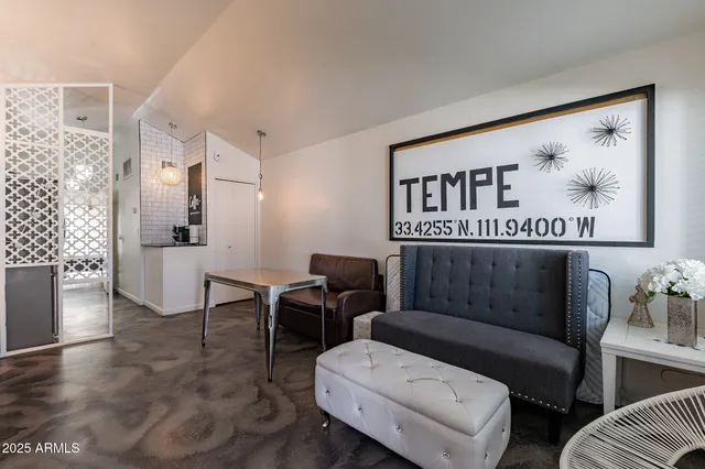 a living room with furniture and a painting