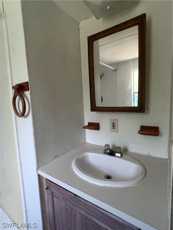 853 Reddish Circle Clewiston, FL 33440 - Photo 8 of 17 a bathroom with a sink and a mirror