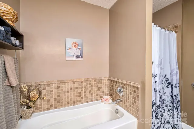 a bathroom with a bathtub and shower