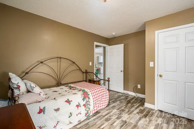 a bedroom with a large bed and a chandelier