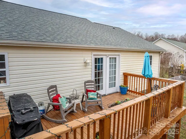a front view of a house with wooden deck