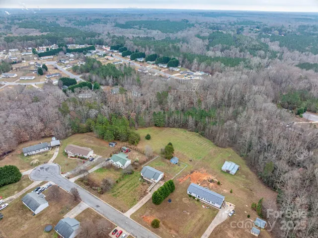 an aerial view of a residential houses with outdoor space