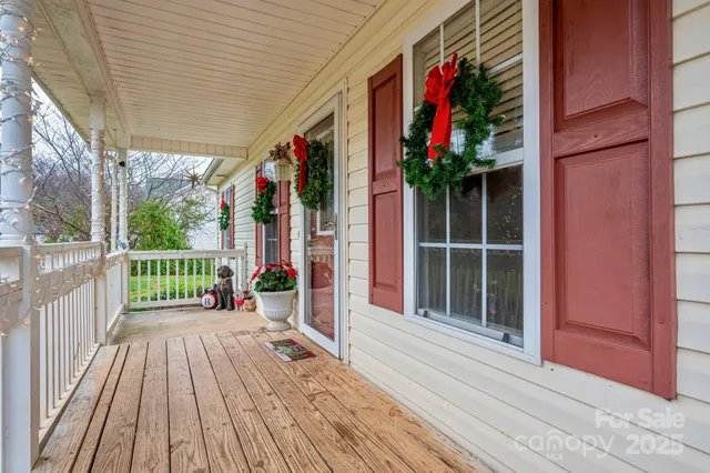 a view of a balcony with wooden floor and potted plants