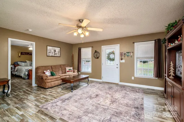 a living room with furniture and a chandelier