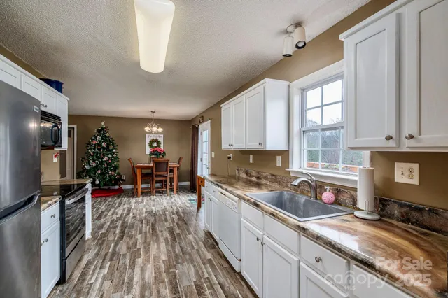 a kitchen with granite countertop lots of counter top space and stainless steel appliances