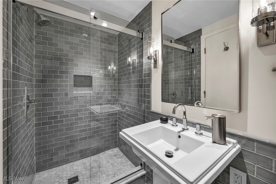13962 Quarry Road Oberlin, OH 44074 - Photo 21 of 43 Bathroom featuring a shower stall and tile walls