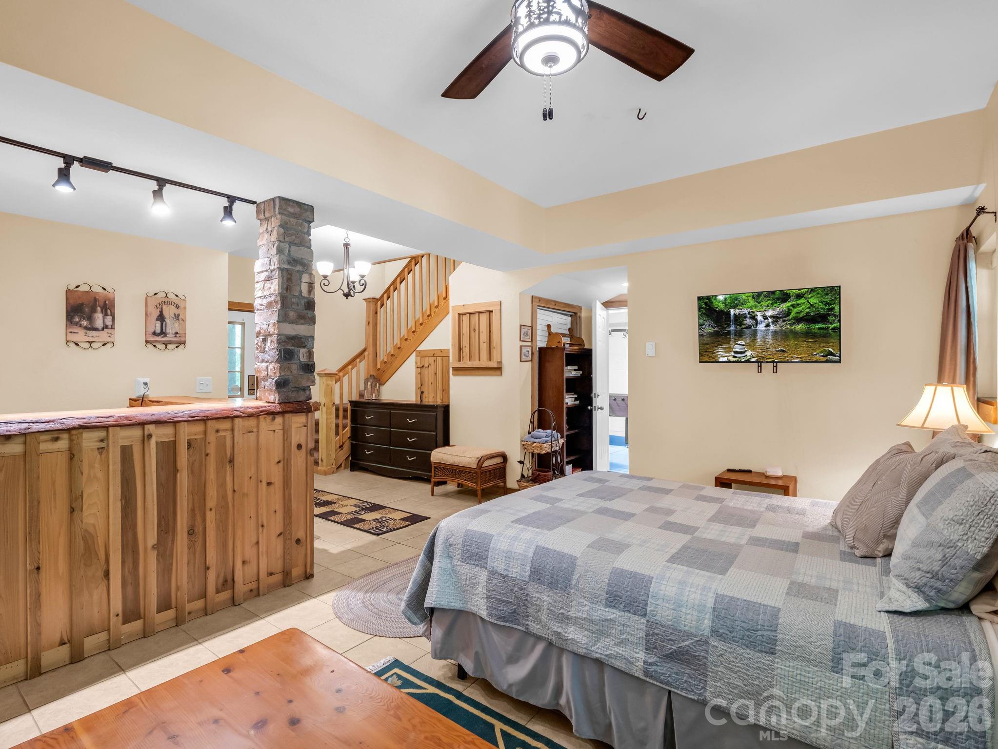 165 Dream Road Hendersonville, NC 28792 - Photo 26 of 46 a bedroom with a large bed and a chandelier