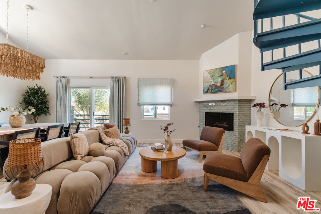 131 Galleon Street, Unit 2 Marina del Rey, CA 90292 - Photo 1 of 21 a living room with furniture a rug and a fireplace